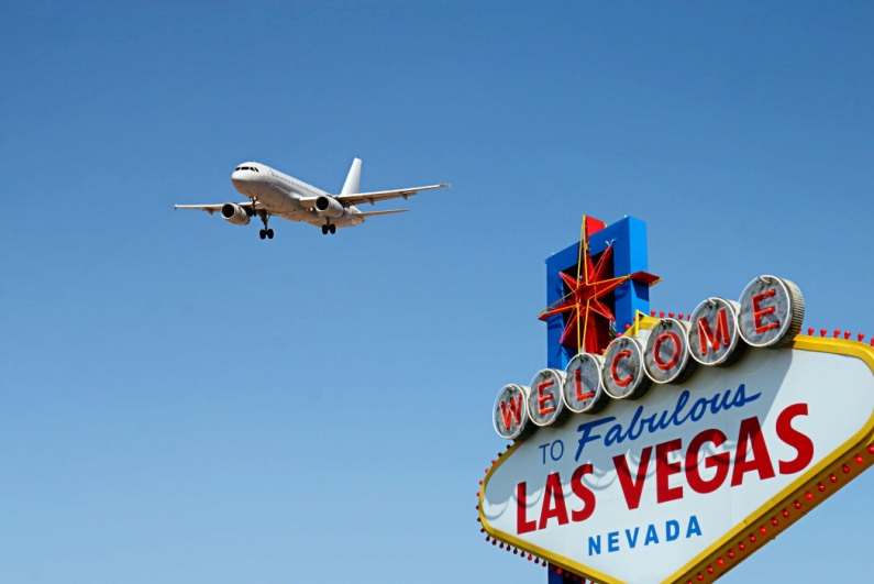Airplane flying over Welcome to Fabulous Las Vegas sign