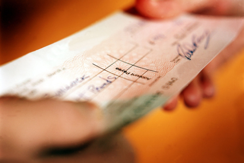 Person handing over a check