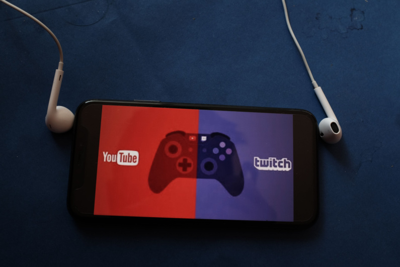 YouTube and Twitch logos on the phone