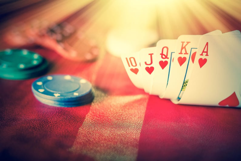 Playing cards with poker chips and heavenly light