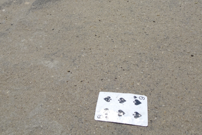 Tattered playing card on the street
