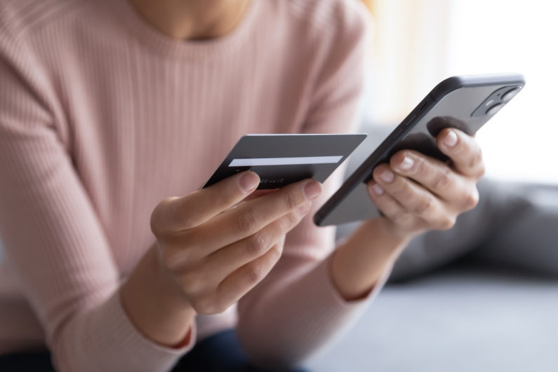 Woman about to make credit card payment on phone