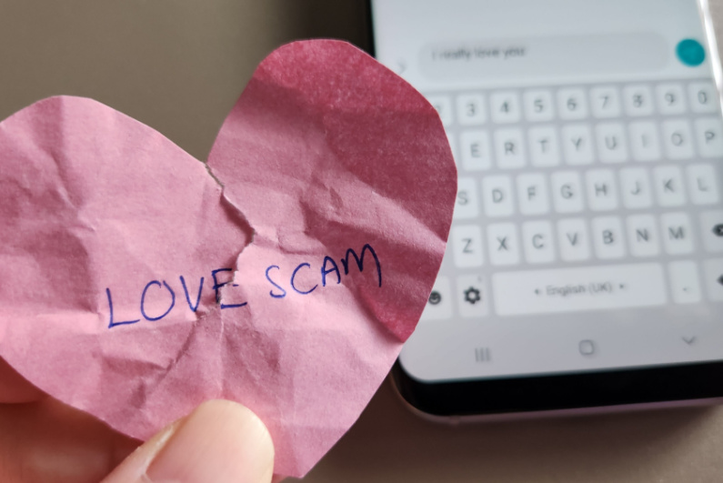 Crumpled up heart reading "LOVE SCAM"