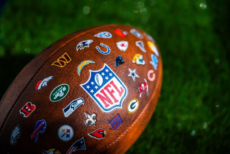 Football emblazoned with team logos