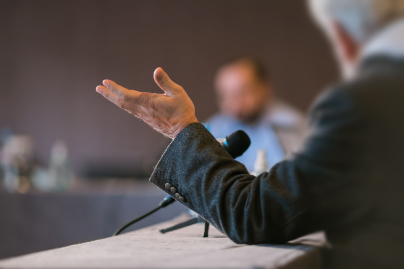 Person talking at a meeting