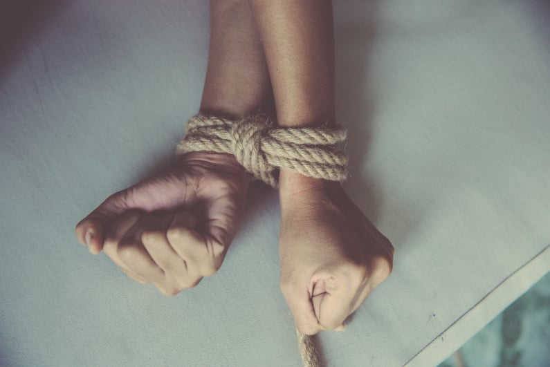 Hands tied by rope