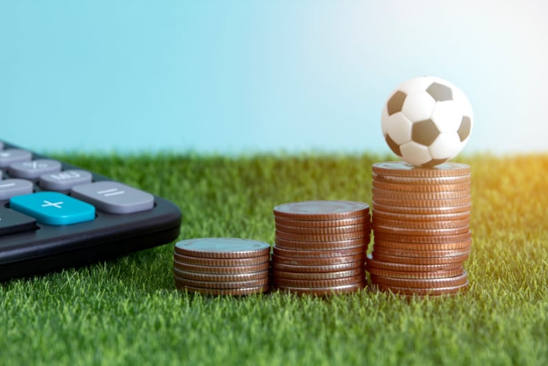Soccer ball on money with calculator