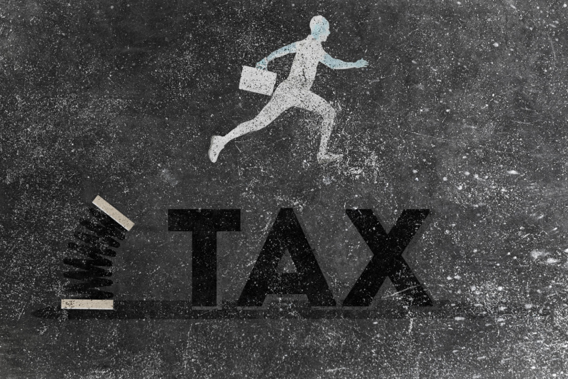 Man jumping over tax wording