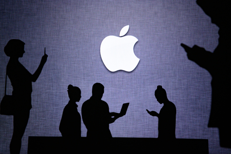 Apple logo surrounded by silhouettes of people using devices