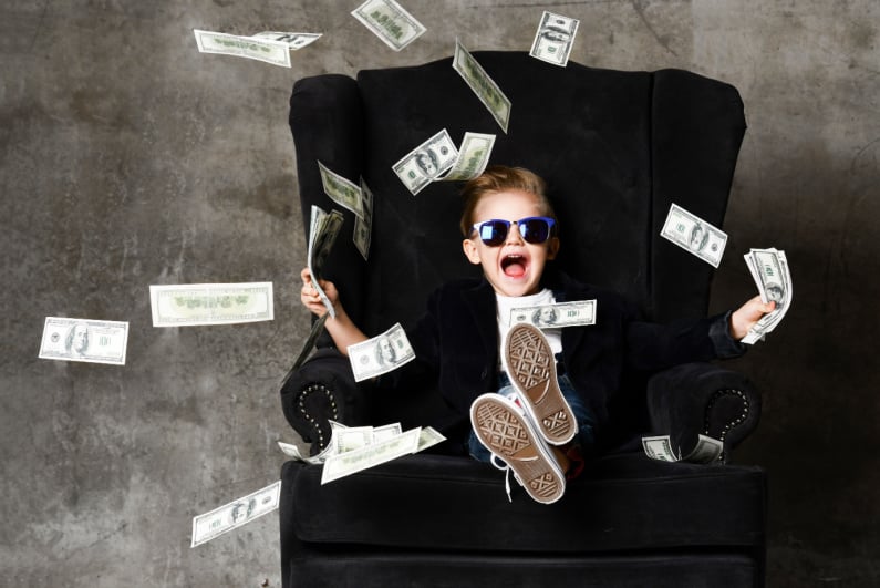 Little kid celebrating falling cash