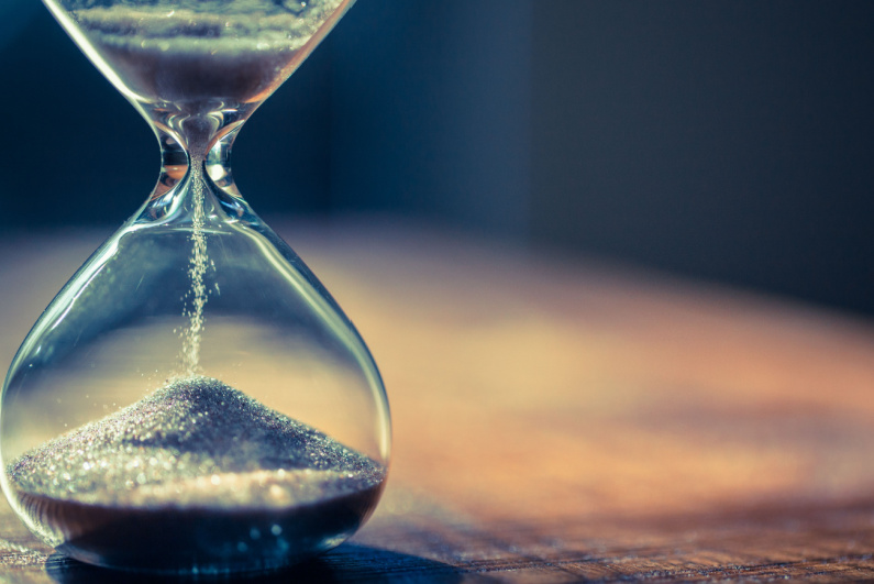 Sand running through an hourglass