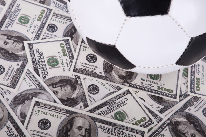 Soccer ball and dollar bills
