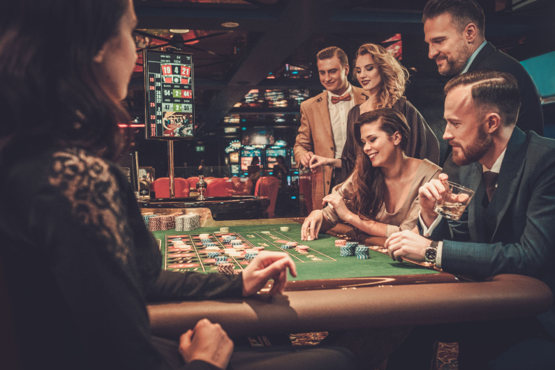 Well-dressed group of gamblers at casino