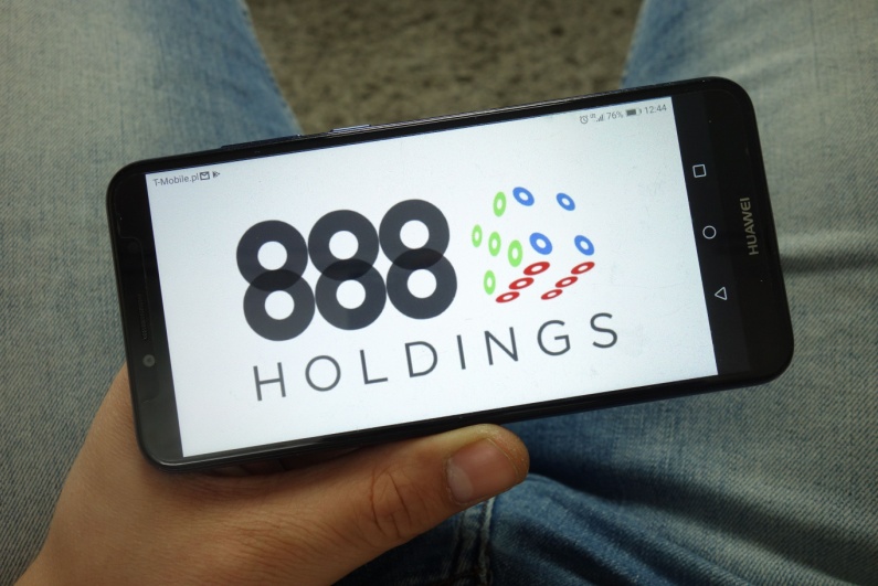 888 Holdings logo on phone