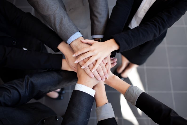 Businesspeople stacking hands