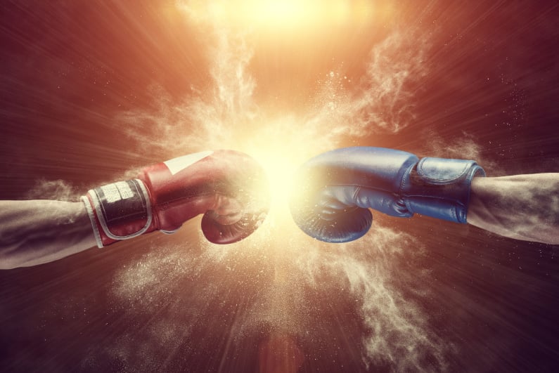 Closeup of boxing gloves colliding