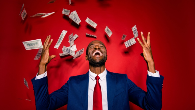 Man celebrating cash windfall