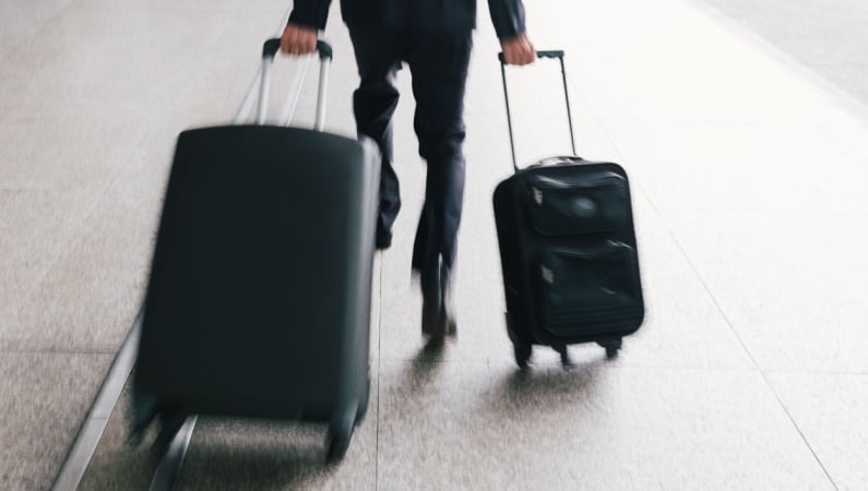 Man rushing with suitcases