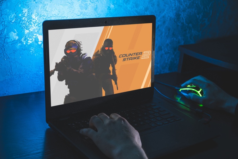 Gamer playing CS2 on a laptop