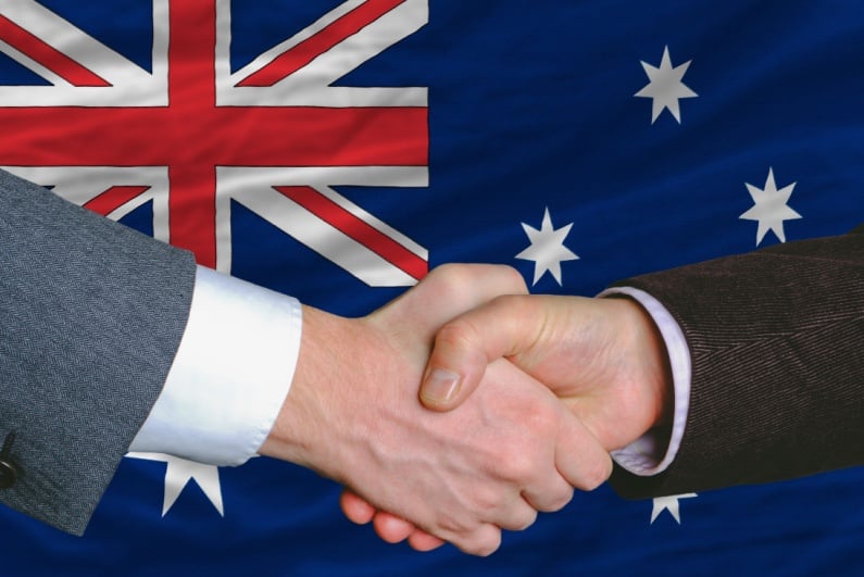 Handshake in front of Australian flag