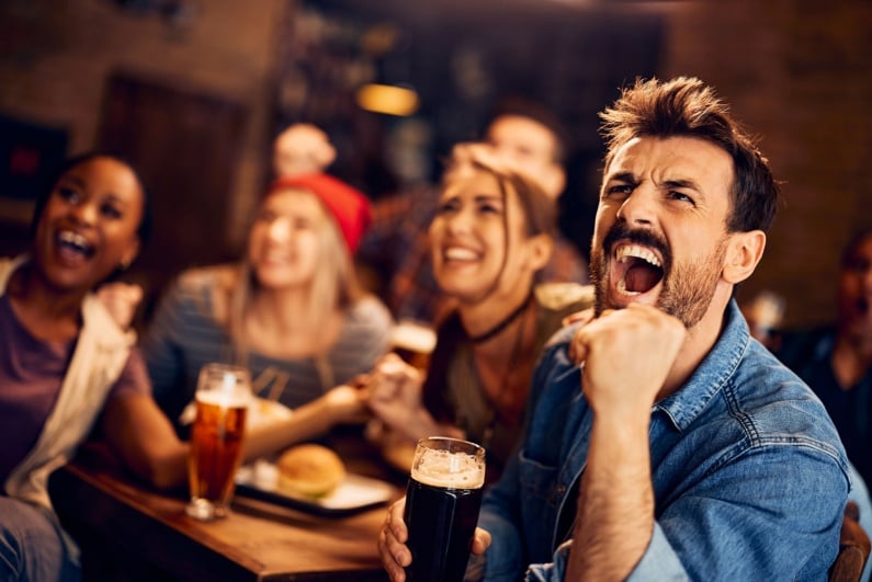 People drinking and watching sports