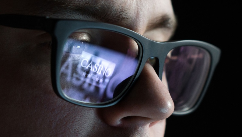 Reflection of the word CASINO in a man's glasses