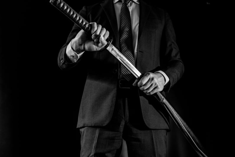 Man in business suit with sword