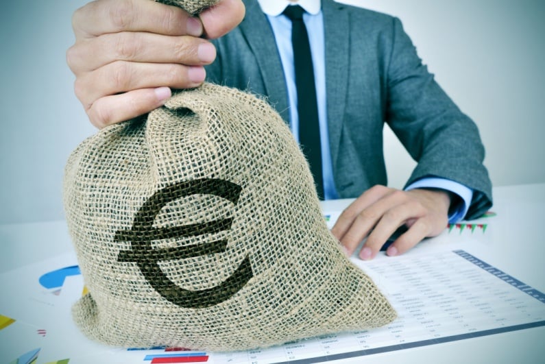 Businessman handing over euros in bag