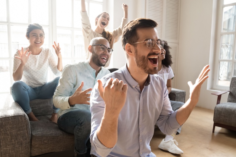 Friends cheering at TV
