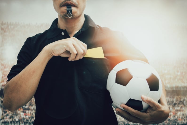 Ref with yellow card and soccer ball