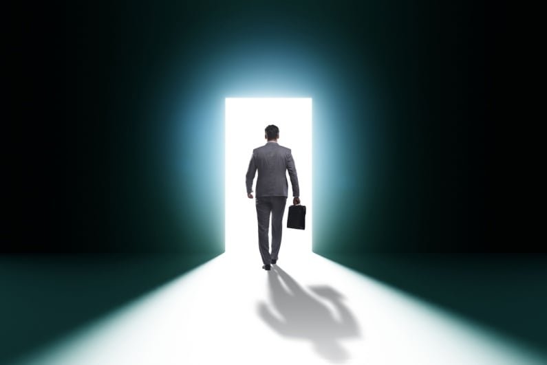 Businessman heading out of door