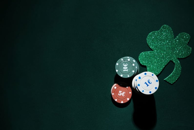 Irish clover with poker chips on felt
