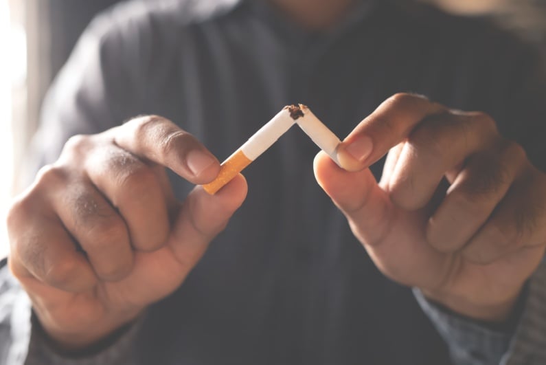 Person breaking a cigarette