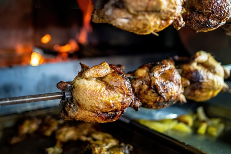 Rotisserie chickens on spit