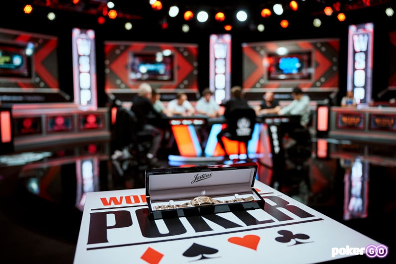 2024 WSOP bracelet with final table in background