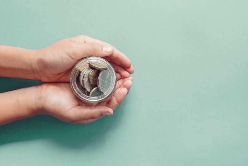 Hands holding donation jar