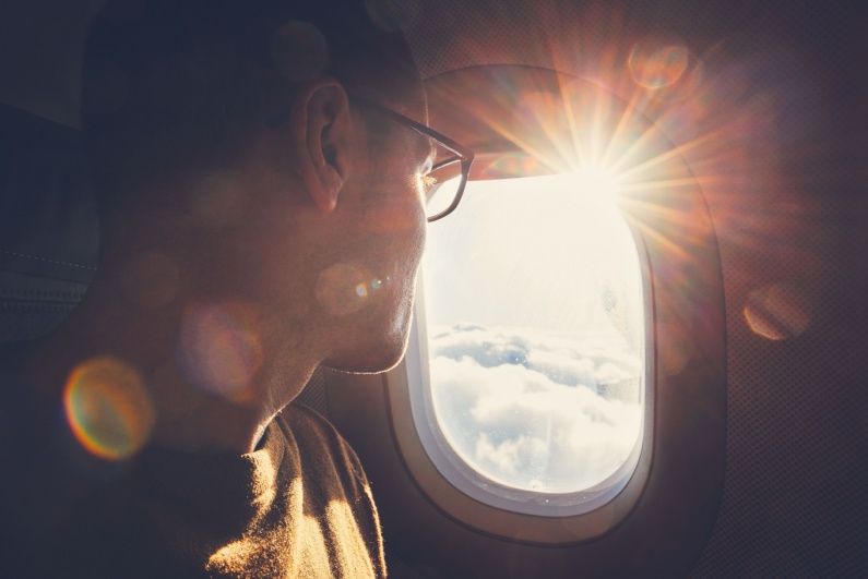 Man looking out an airplane window