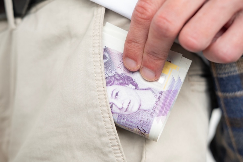 Person putting money in pocket