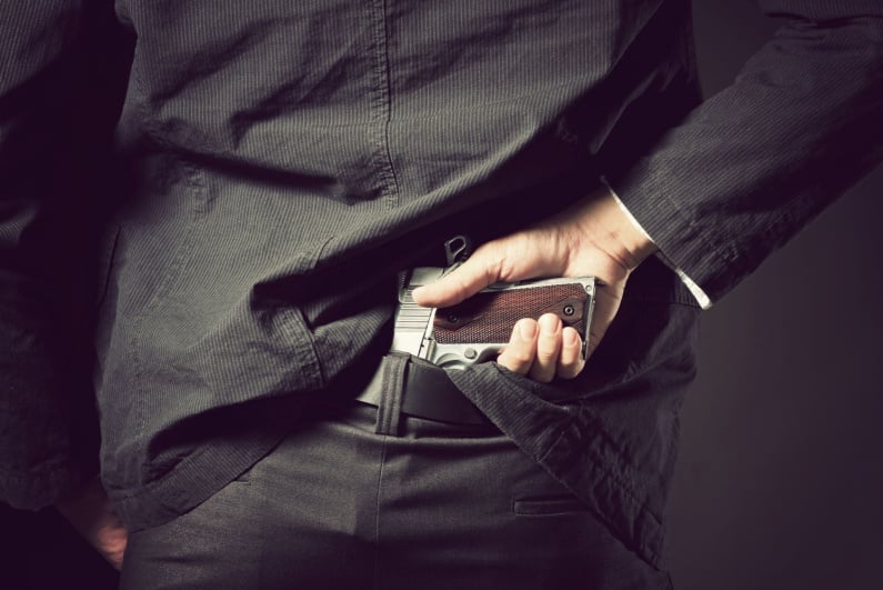 Man hiding gun in waist
