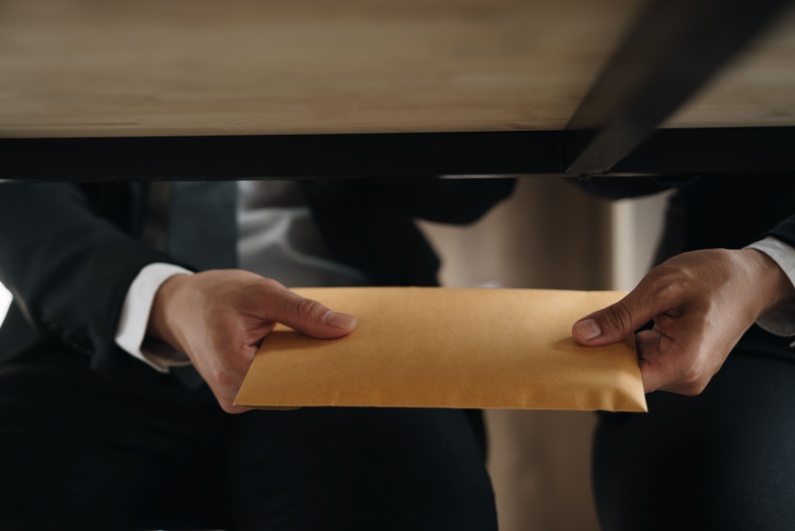 Passing envelope under the table