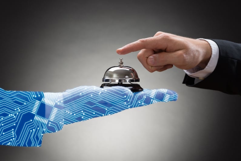 Man ringing hotel bell held by computerized hand