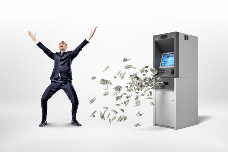 Man celebrating ATM spewing money