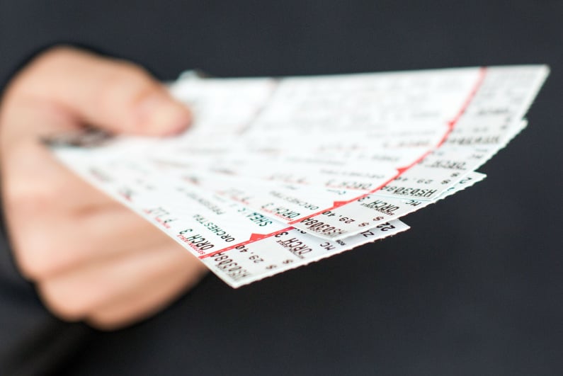 Person holding event tickets