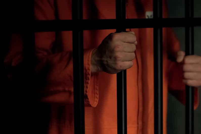 Prisoner behind bars