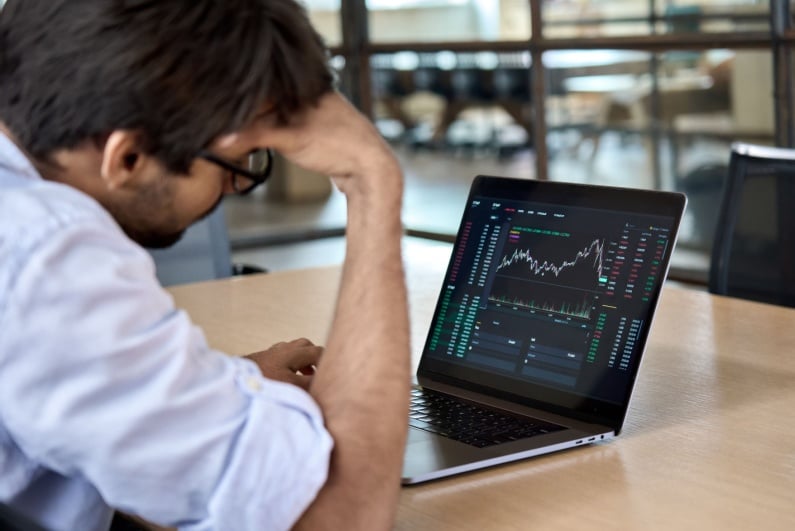 Man watching a dropping share price