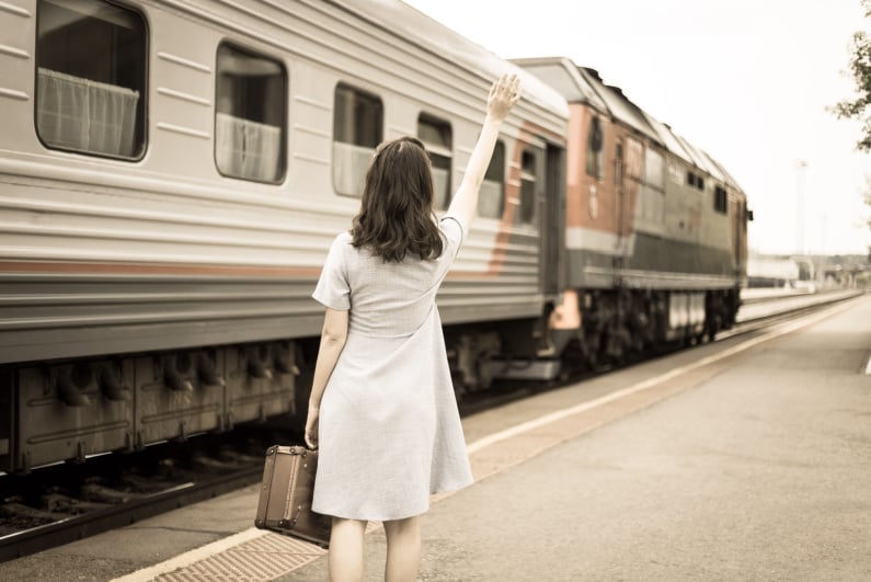 Woman waving goodbye to train