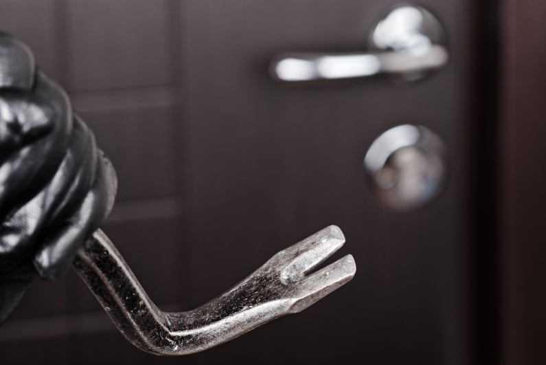 Burglar holding crowbar