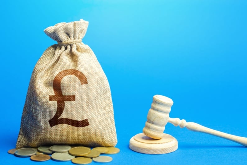 Judge gavel and sack of British pounds