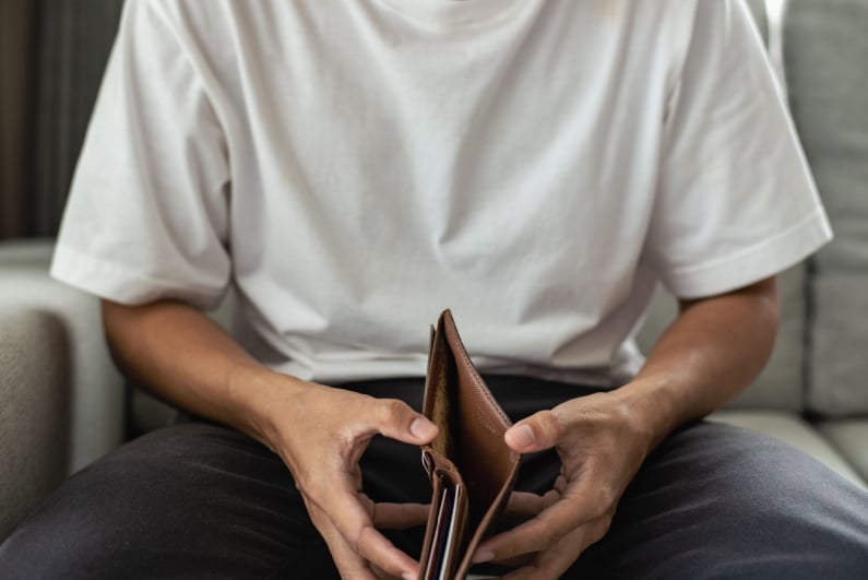 Man holding empty wallet