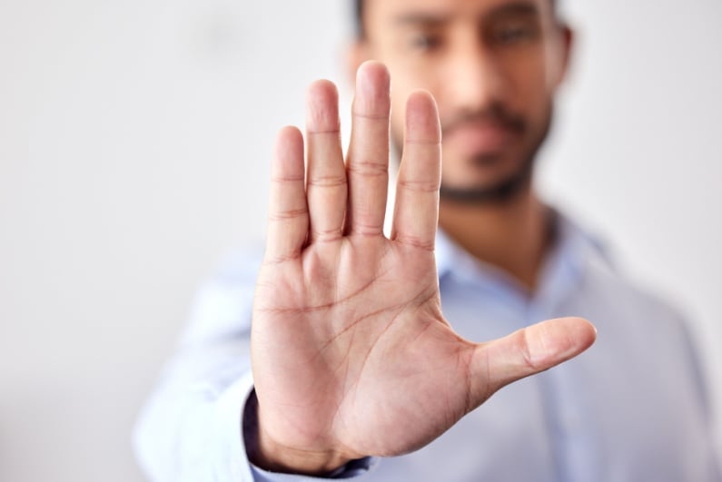 Man holding out hand to say no